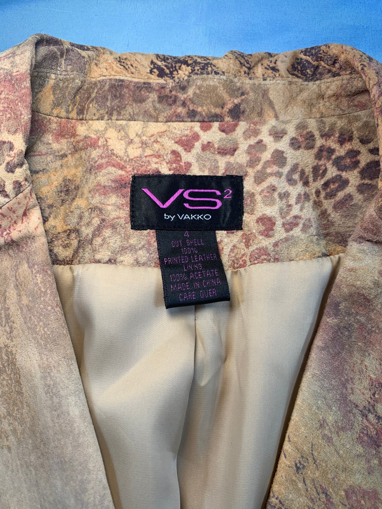 Patterned fabric with a Vakko label on a blue background