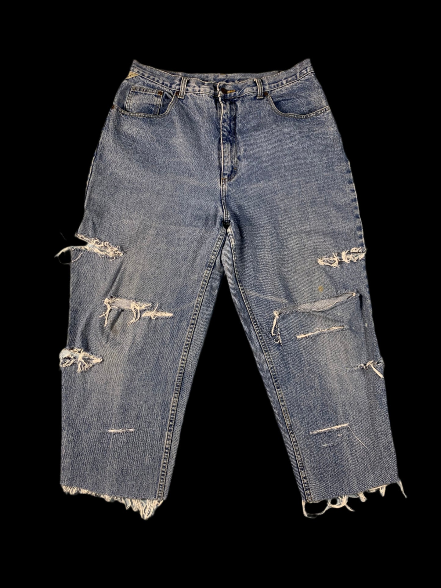 Pair of distressed blue jeans on a light gray background