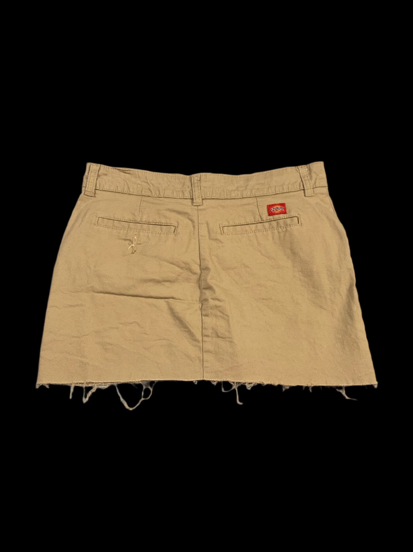 Beige shorts with a brand logo on a gray background