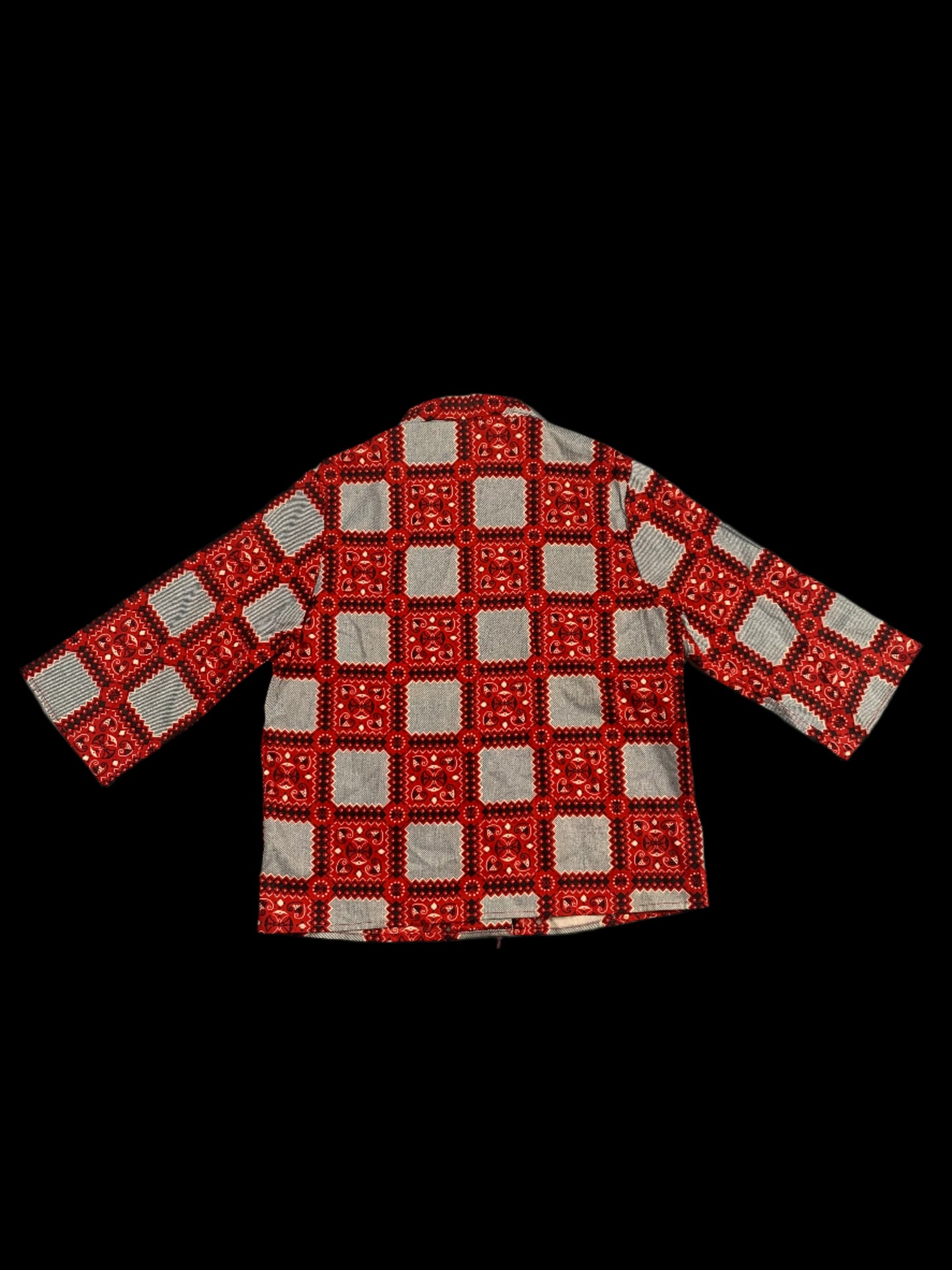 Red and white patterned tie on a light gray background