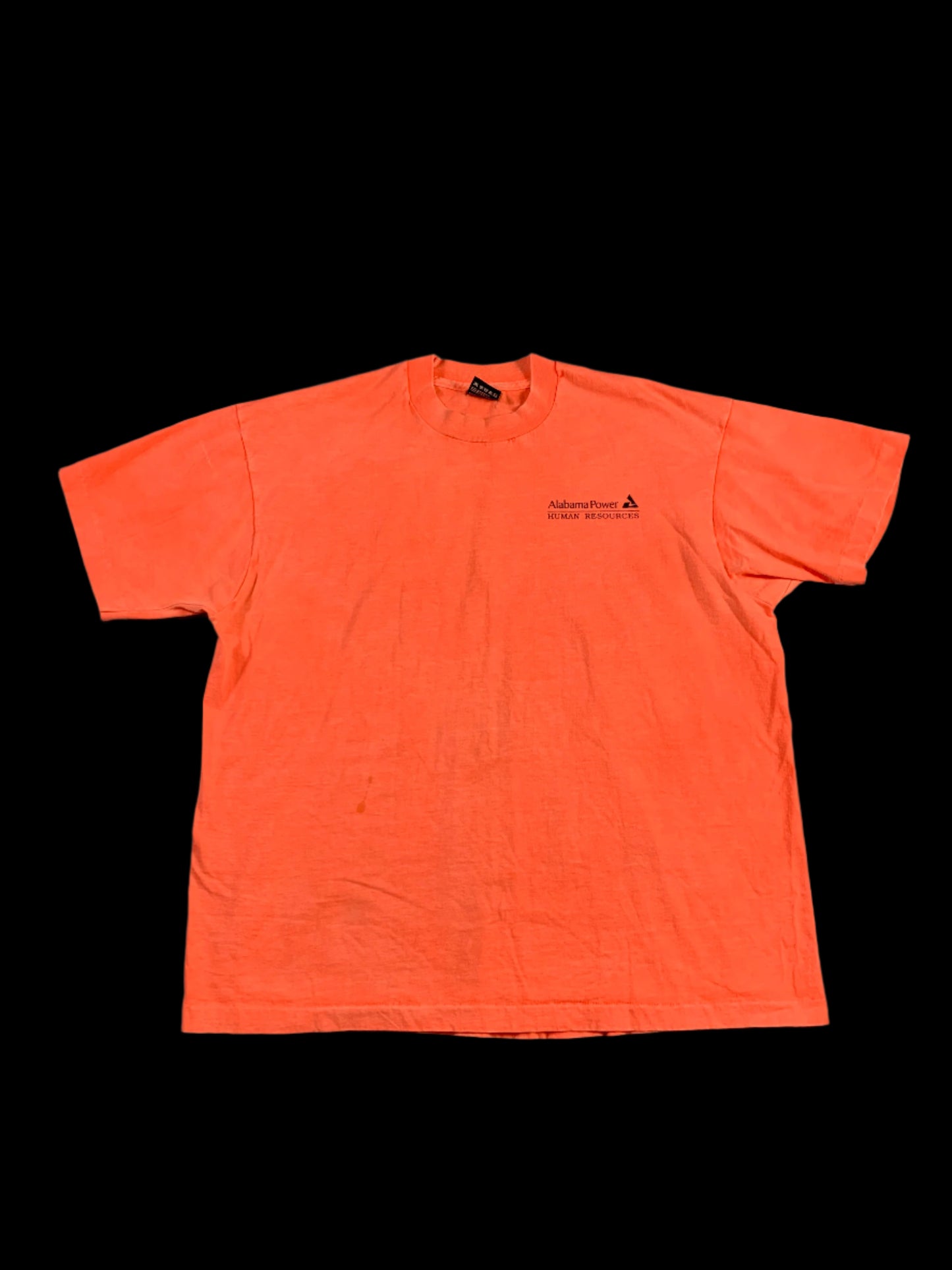 Orange long-sleeve shirt on a gray surface