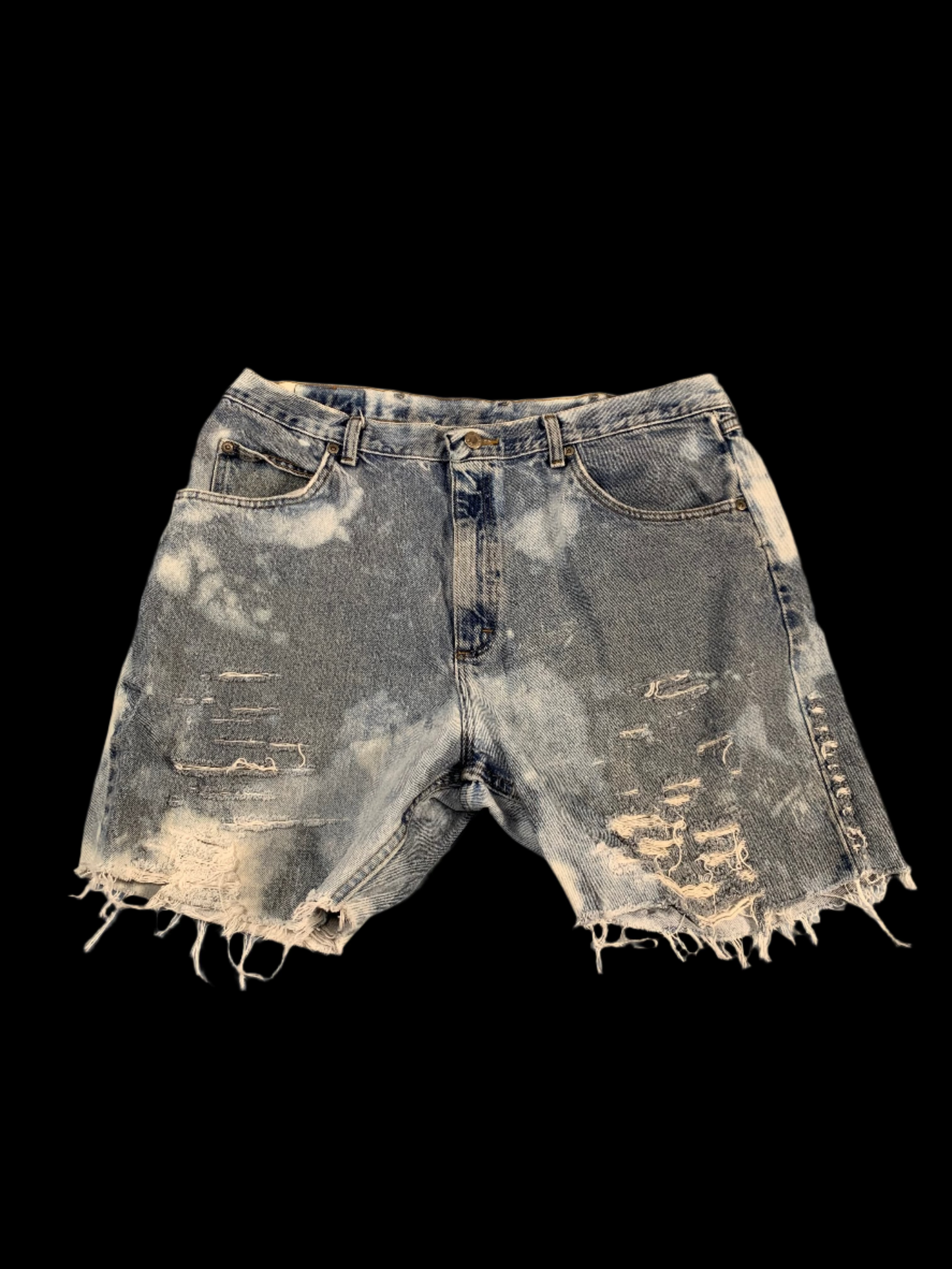 Distressed denim shorts on a gray background