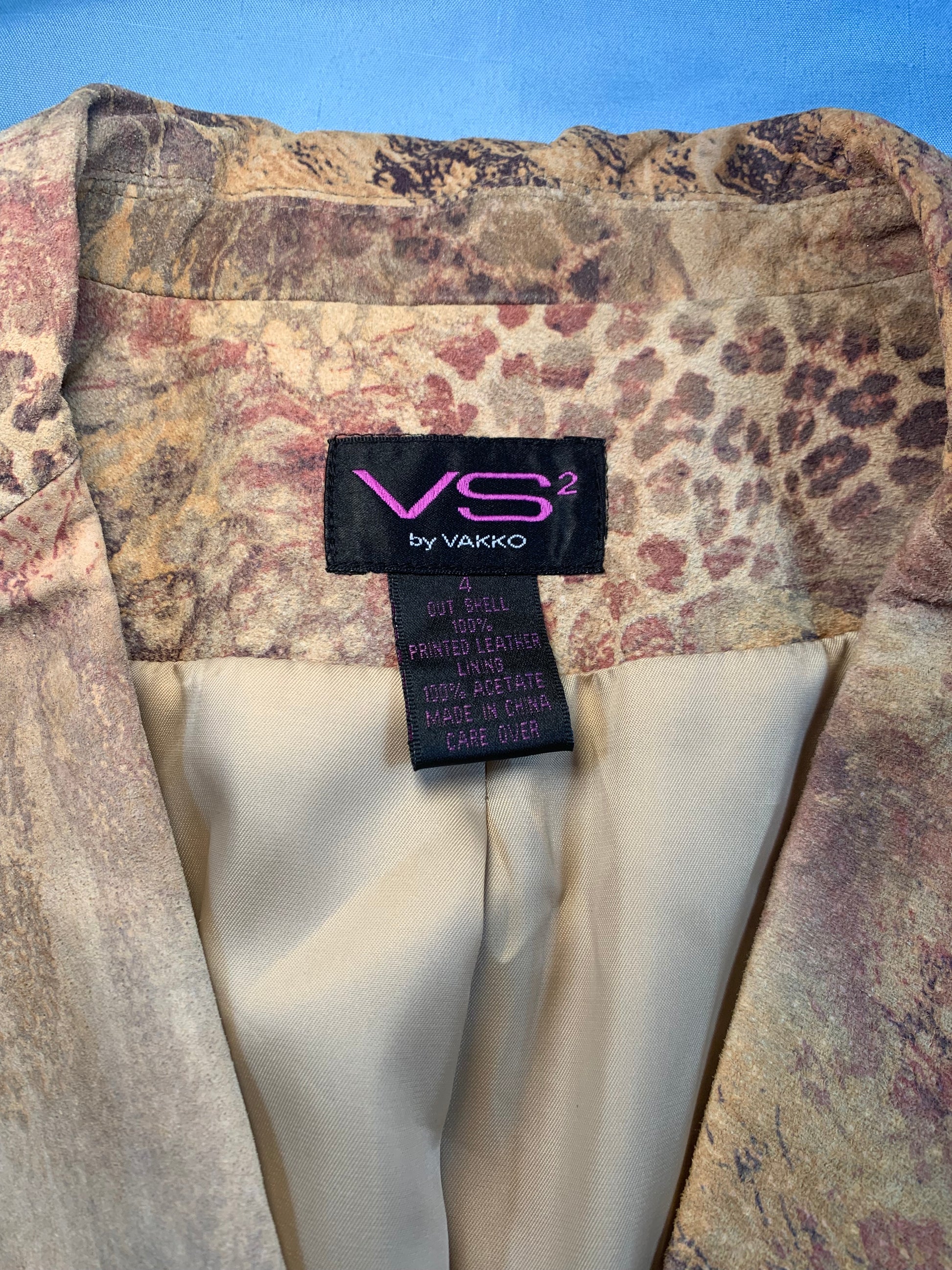 Patterned fabric with a Vakko label on a blue background