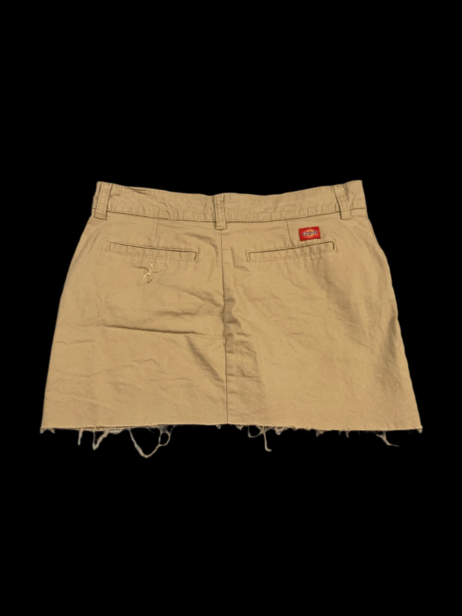 Beige shorts with a brand logo on a gray background
