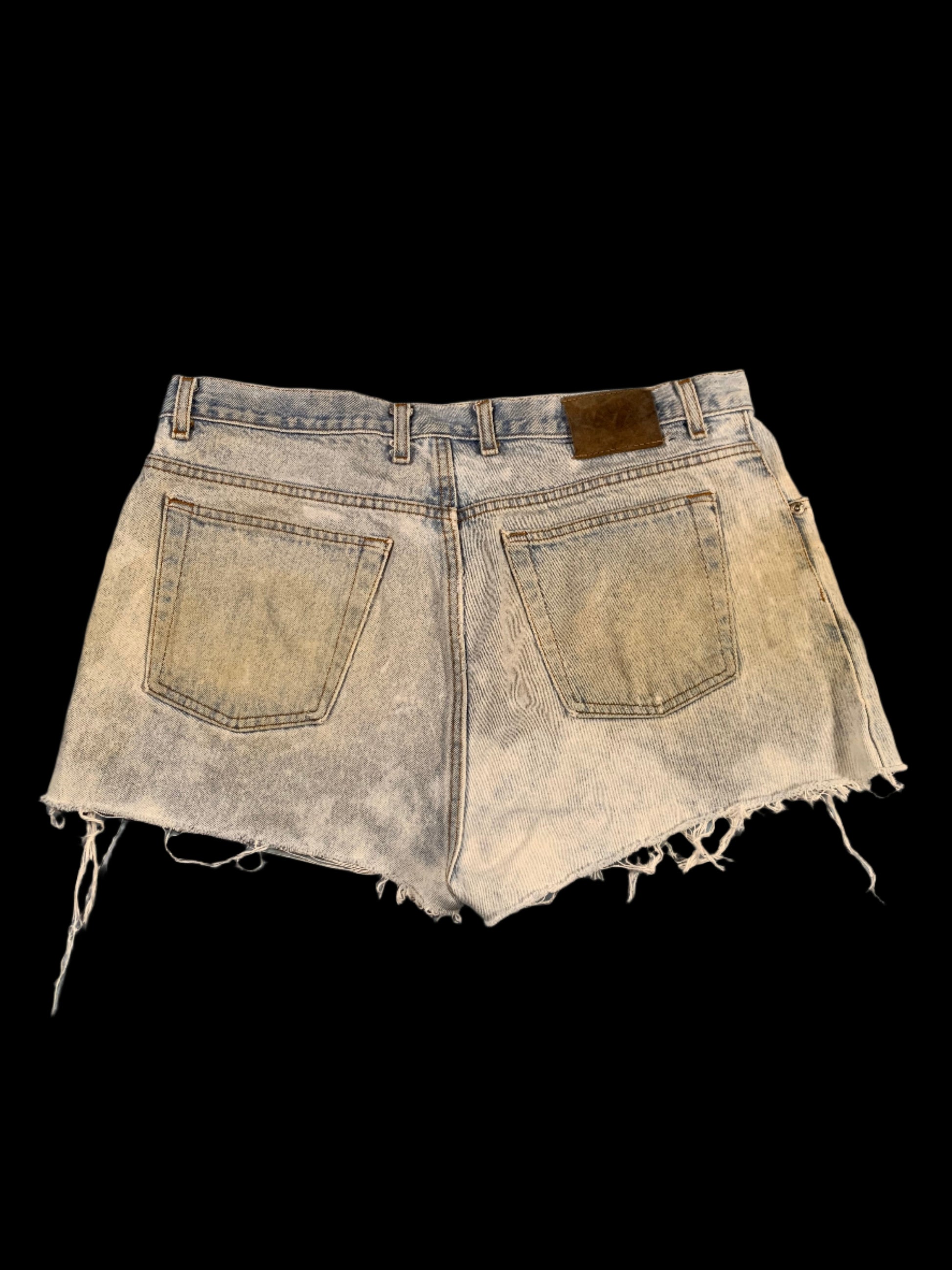 Distressed denim shorts on a gray background