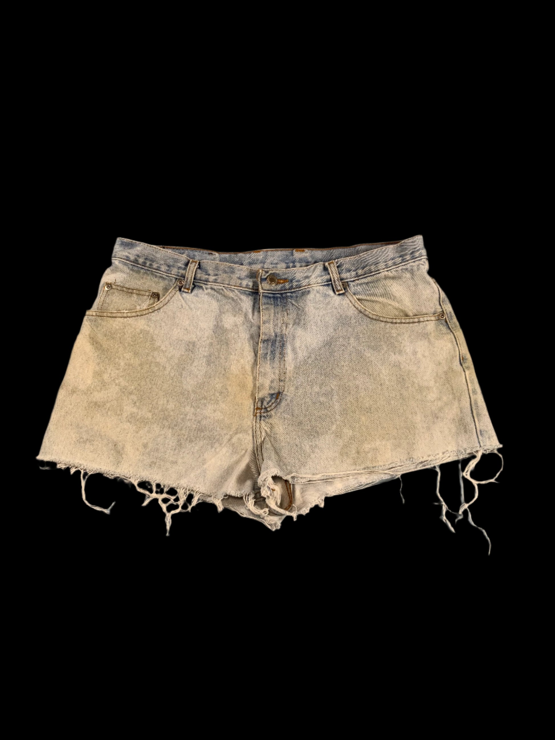 Distressed denim shorts on a gray surface
