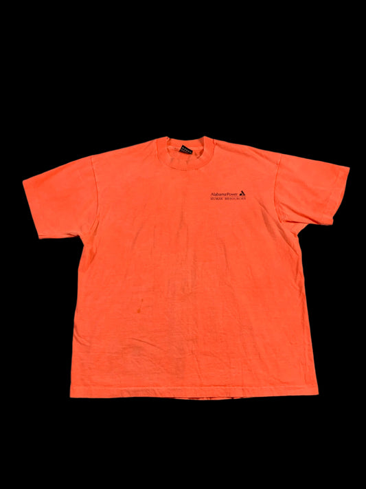 Orange long-sleeve shirt on a gray surface