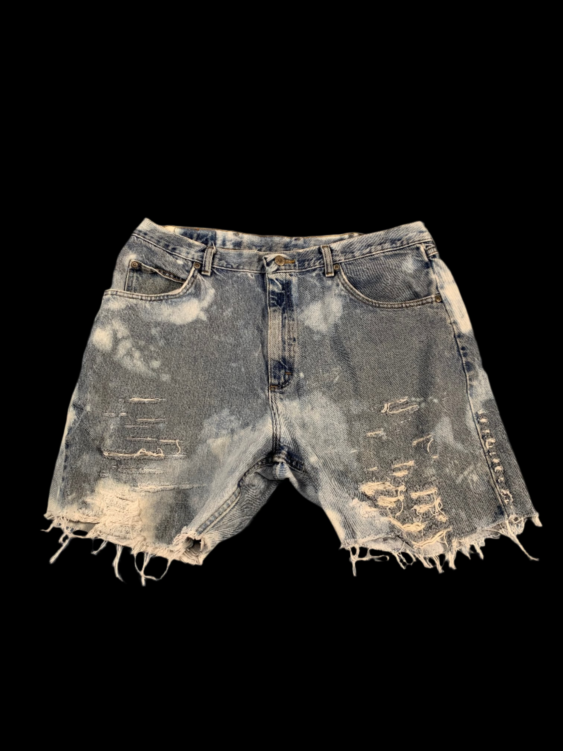 Distressed denim shorts on a gray background